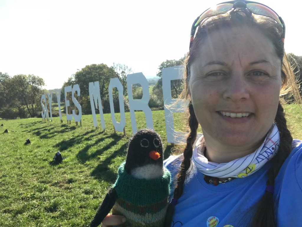 Me with Isabella Bird the penguin of future adventure on front of the Say Yes More sign