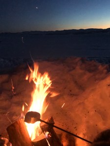 Marshmallow toasting on a fire in the snow