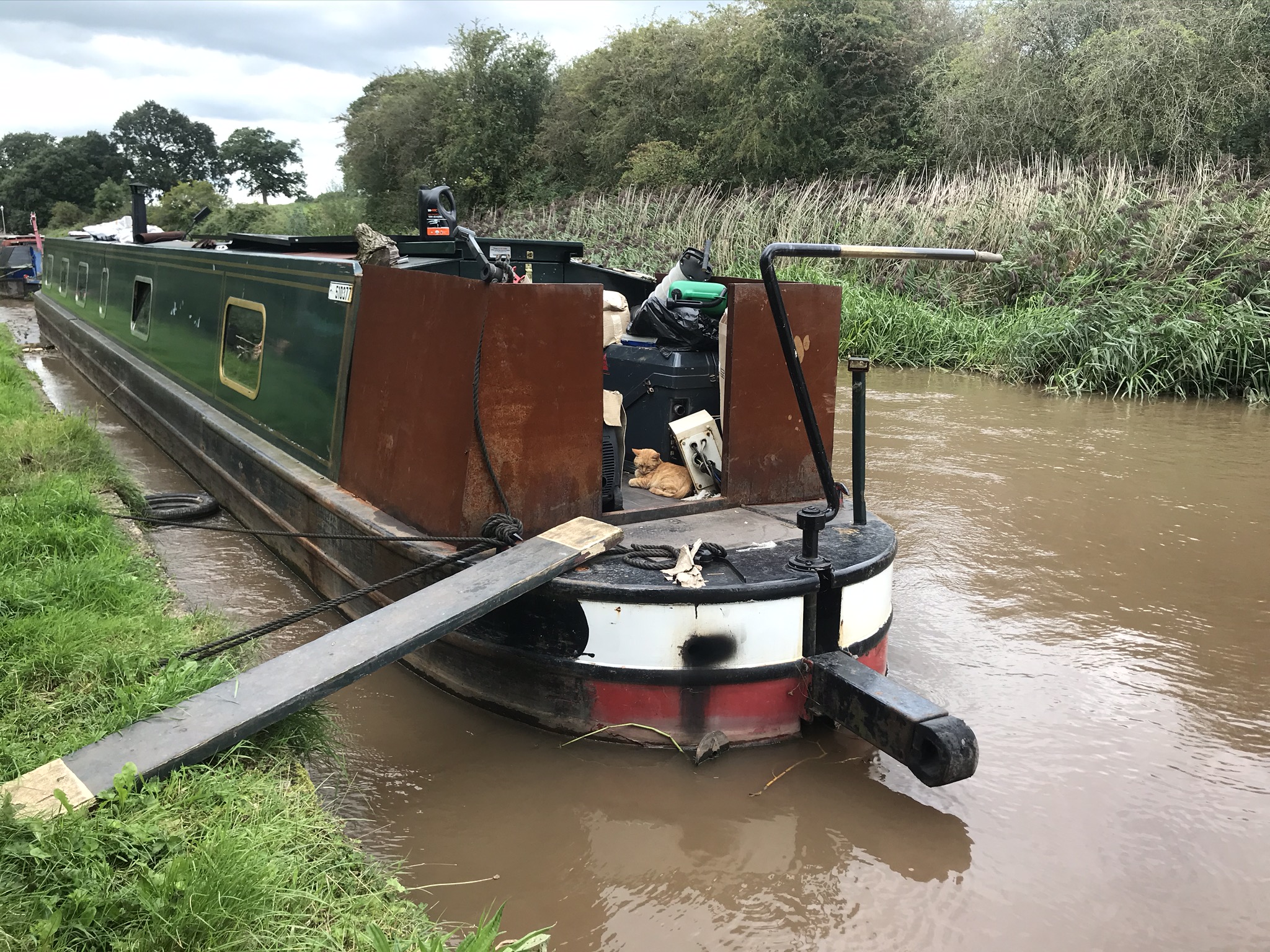 A ginger cat asleep on a narrowboat