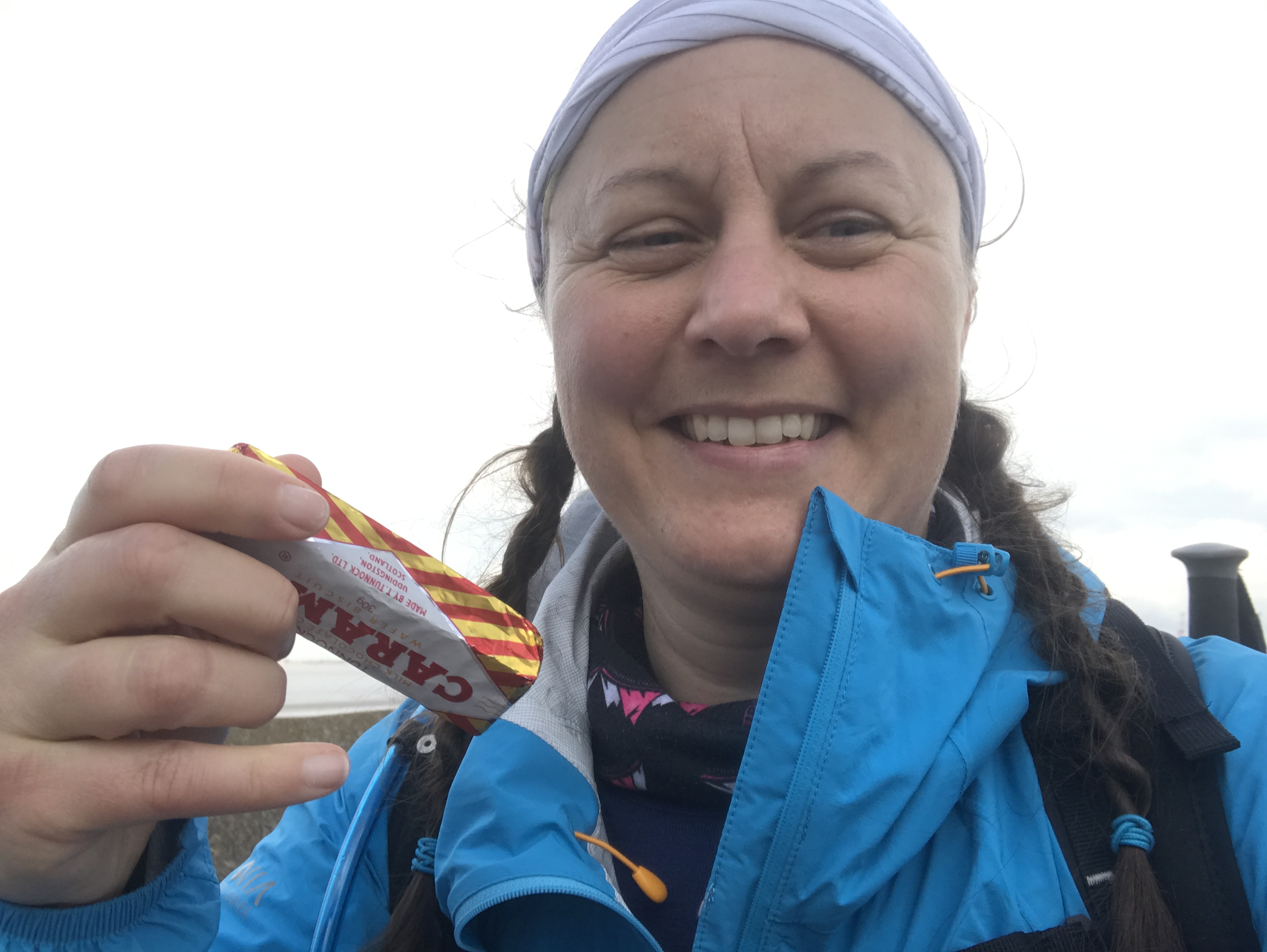 Ellen smiles at the camera holding a Tunnock's caramel wafer