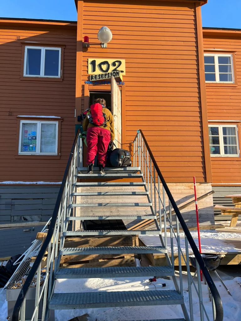 Me climbing the metal steps into the guesthouse